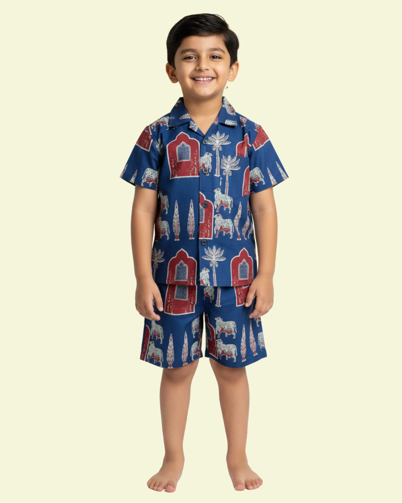 Child wearing a blue pajama set with animal patterns on a beige background, featuring text 'Kids Cord Sets' and '10% off'.

