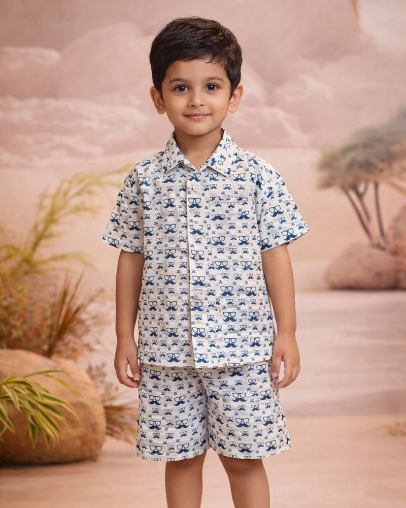A boy wearing a white color boys specs printed pure cotton summer shorts set